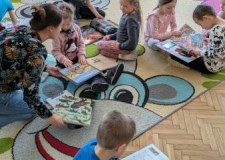 Powiększ zdjęcie Dzieci przeglądają biblioteczne książki 